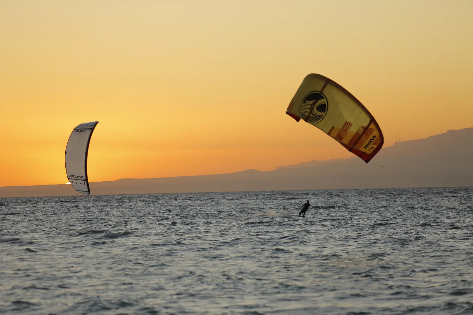 Kitesurfers riding at golden hour in Ras Sudr